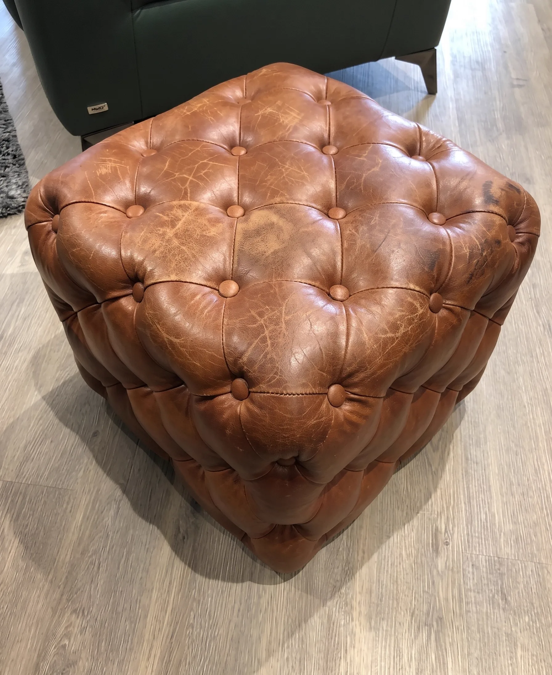 Faded, worn brown leather sofa before restoration